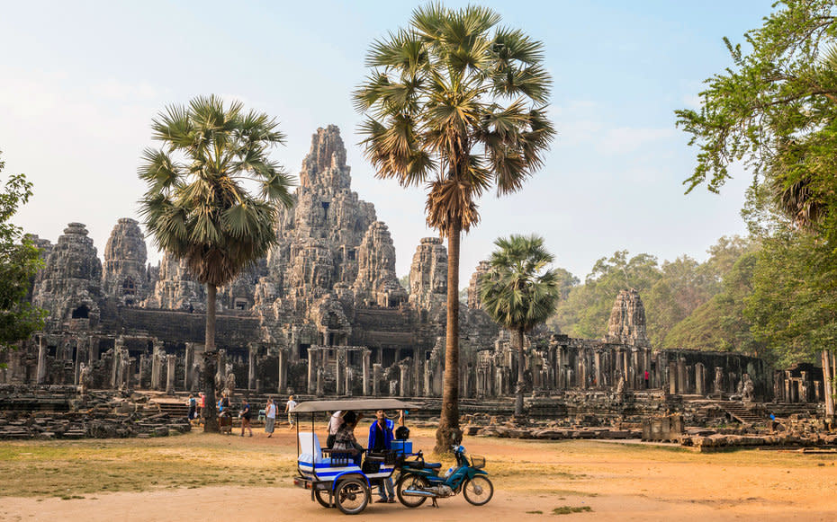 <p><strong>What to See: </strong>The 12th-century <a rel="nofollow noopener" href="http://www.travelandleisure.com/articles/angkor-wat-behavior-video" target="_blank" data-ylk="slk:Angkor Wat;elm:context_link;itc:0;sec:content-canvas" class="link ">Angkor Wat</a> is the largest religious monument in the world, filling an area of over 400 acres. Built originally as a temple to the Hindu god Vishnu, over the period of its construction the complex gradually became Buddhist. Its incredible grandeur is a testament to human accomplishment. (UNESCO agrees.)</p><p><strong>Where to Stay: </strong>The <a rel="nofollow noopener" href="http://www.goldentempleresidence.com/home" target="_blank" data-ylk="slk:Golden Temple Residence;elm:context_link;itc:0;sec:content-canvas" class="link ">Golden Temple Residence</a> provides a luxurious haven after a long day of tromping around outdoors. Cool down with a cocktail in their swim-up bar.</p><p><strong>What to Eat: </strong><a rel="nofollow noopener" href="https://www.facebook.com/GenevievesRestaurant#_=_" target="_blank" data-ylk="slk:Genevieves;elm:context_link;itc:0;sec:content-canvas" class="link ">Genevieves</a> offers both local Khmer and international Western dishes, both to great acclaim.</p>