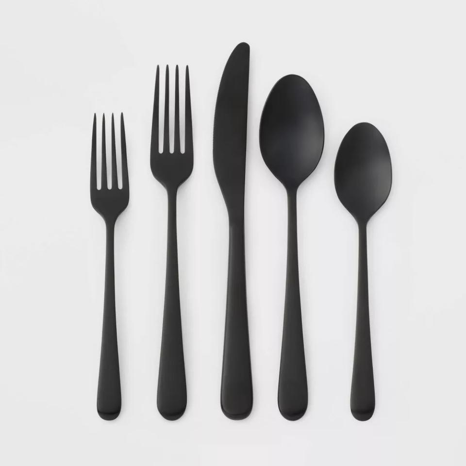 Five pieces of black silverware on white background