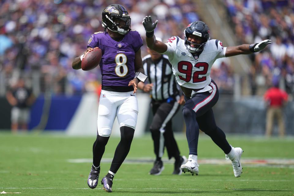 Baltimore Ravens quarterback Lamar Jackson (8) pressured by Houston Texans defensive end Dylan Horton during the season opener on Sept. 10, 2023.