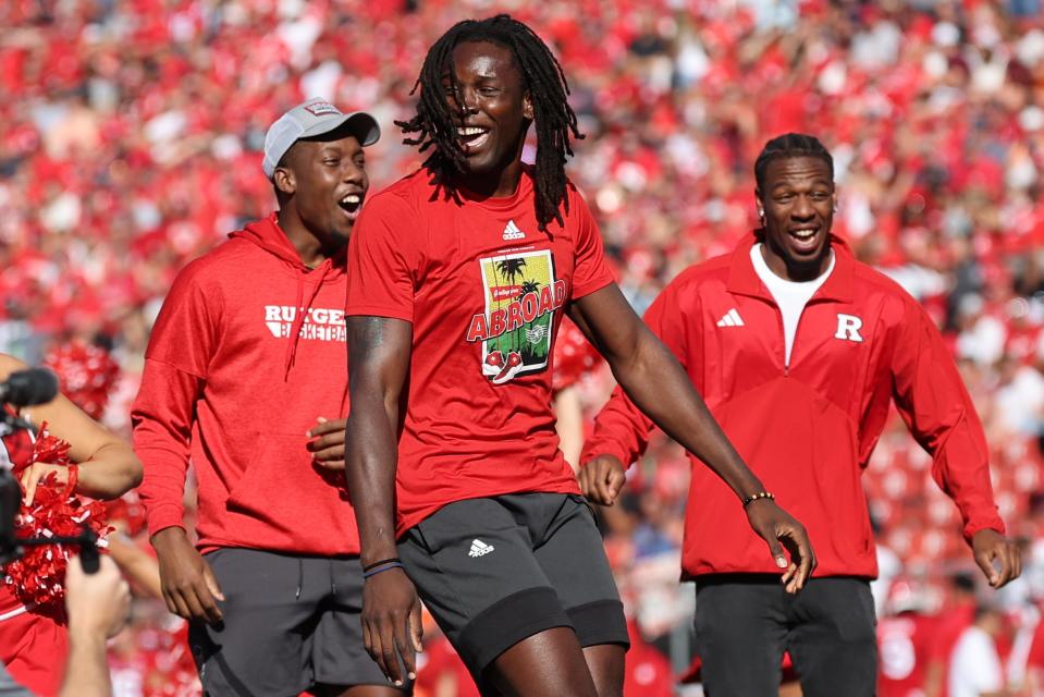 Sep 16, 2023; Piscataway, New Jersey, USA; Rutgers basketball center Clifford Omoruyi (center) and forward Aundre Hyatt (left) and guard Jeremiah Williams (right) perform a dance routine during the football game against Virginia Tech at SHI Stadium.