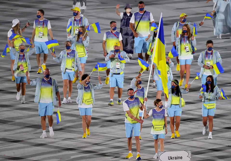 The athletes wore multicolored shirts with matching shorts that reflected the colors of their flags