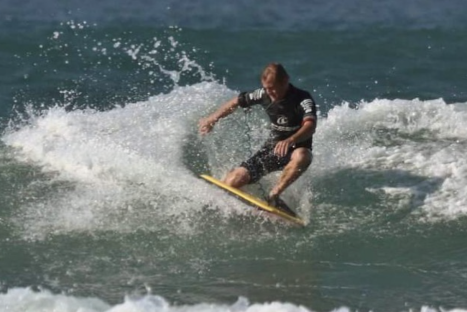 Robert Frauenstein, 38, is pictured surfing.