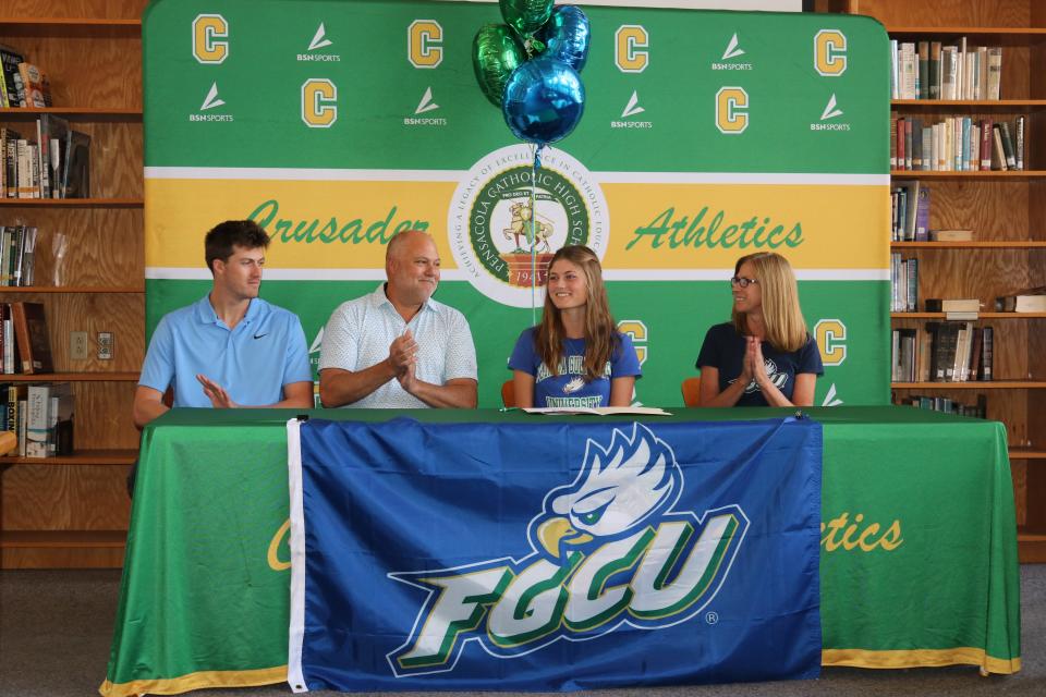 Pensacola Catholic senior Islay Benoit signs her letter of intent to join the Florida Gulf Coast University women's golf team on Wednesday, Nov. 8, 2023 from Pensacola Catholic High School media center.