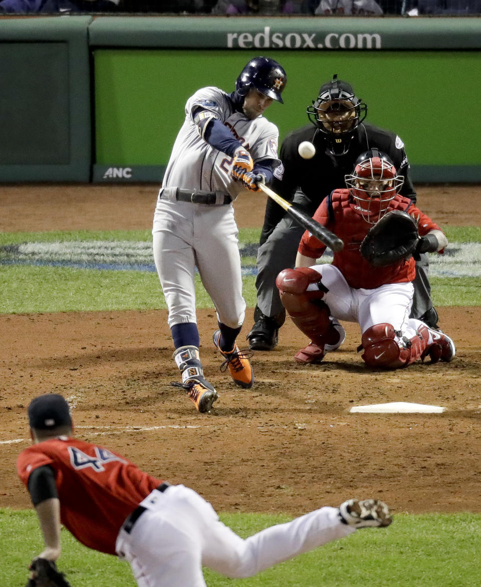 Houston Astros' Josh Reddick hits a home run against the Boston Red Sox during the ninth inning in Game 1 of a baseball American League Championship Series on Saturday, Oct. 13, 2018, in Boston. (AP Photo/Elise Amendola)