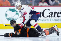 Washington Capitals' Lars Eller (20) collides with Philadelphia Flyers' Morgan Frost (48) during the third period of an NHL hockey game, Wednesday, Dec. 7, 2022, in Philadelphia. (AP Photo/Matt Slocum)