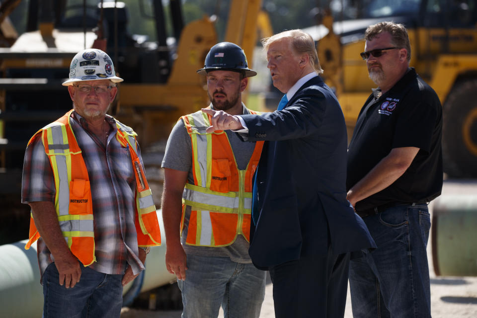 President Donald Trump takes a tour before speaking about energy and infrastructure at the International Union of Operating Engineers International Training and Education Center, Wednesday, April 10, 2019, in Crosby, Texas. (AP Photo/Evan Vucci)