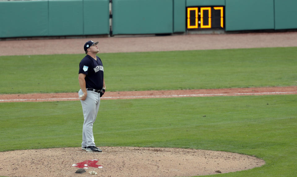 New York Yankees pitcher Cale Coshow prepares to pitch as the pitching clock winds down during a spring training baseball game against the Boston Red Sox in Fort Myers, Fla., Saturday, Feb. 23, 2019. (AP Photo/Gerald Herbert)