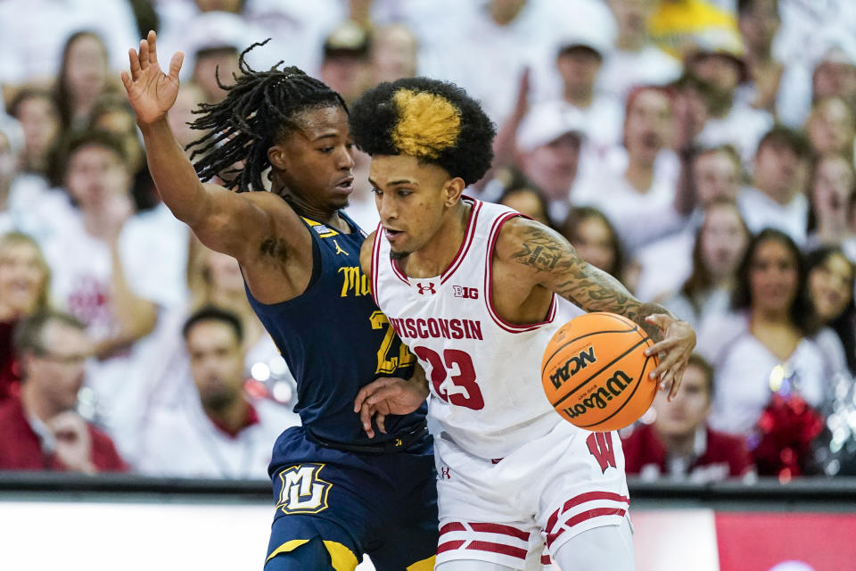 Wisconsin's Chucky Hepburn (23) drives against Marquette's Sean Jones (22) during the first half of an NCAA college basketball game, Saturday, Dec. 2, 2023, in Madison, Wis. (AP Photo/Andy Manis)
