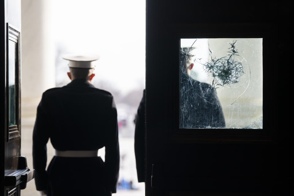 U.S. Marine Corps. sentries outside a damaged door at the Capitol during a rehearsal for the 59th inaugural ceremony for President-elect Joe Biden and Vice President-elect Kamala Harris on Monday, January 18, 2021 at the U.S. Capitol in Washington. (Jim Lo Scalzo/Pool via AP)