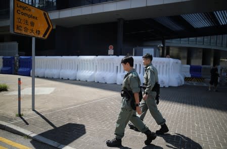 Police officers patrol outside the Legislative Council Complex, in central Hong Kong