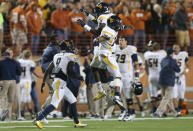 (L-R) KJ Myers #19 and Dustin Brown #23 of the West Virginia Mountaineers celebrate on the field during a game against the Texas Longhorns at Darrell K Royal-Texas Memorial Stadium on October 6, 2012 in Austin, Texas. (Photo by Ronald Martinez/Getty Images)