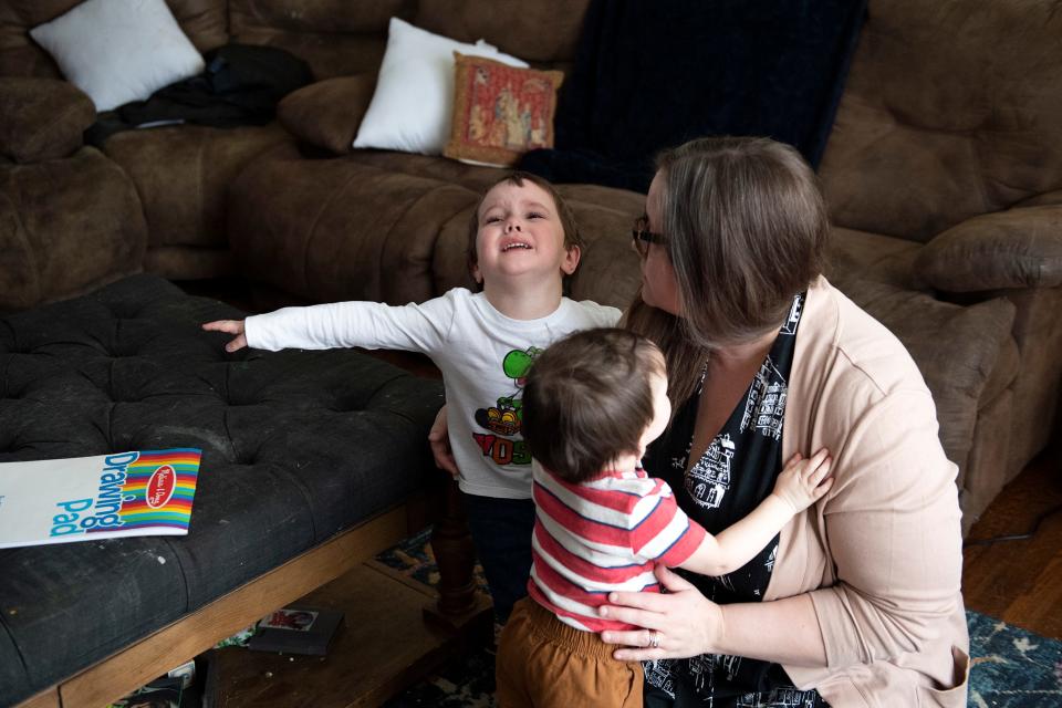 Katherine Hart's older son becomes upset while playing with his mother and younger brother at their home in Medford Lakes, NJ.