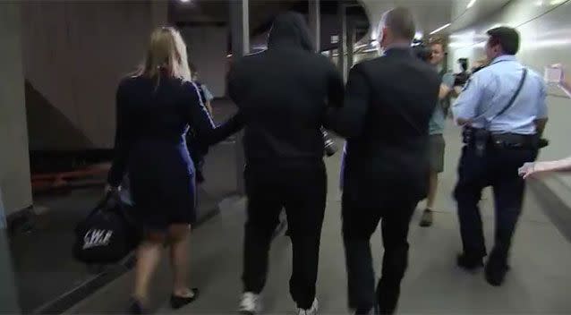 Following the arrest, he was then walked past waiting media. Picture: NSW Police