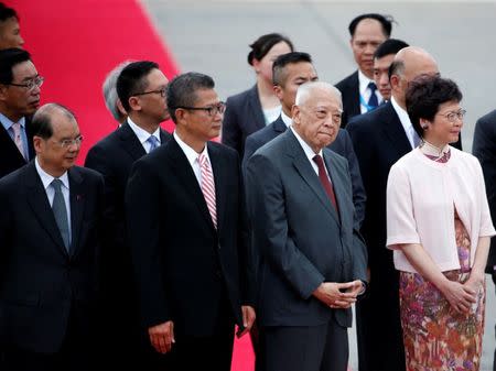 (Front L-R) Hong Kong Chief Secretary Matthew Cheung, Financial Secretary Paul Chan, former Chief Executive Tung Chee-hwa and new Chief Executive Carrie Lam wait for the arrival of Chinese President Xi Jinping (not pictured) at Hong Kong airport, China, ahead of celebrations marking the city's handover from British to Chinese rule, June 29, 2017. REUTERS/Bobby Yip