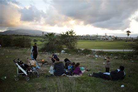 Syrian refugees pass the time outside a refugee centre in Spain's north African enclave Melilla December 8, 2013. REUTERS/Juan Medina