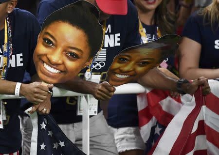 Fans hold cutouts of Simone Biles during the women's team final. REUTERS/Dylan Martinez