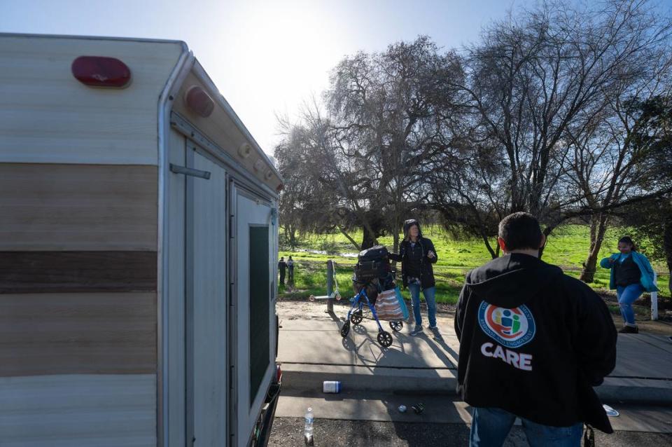 Workers count unsheltered homeless people in the Airport district of Modesto, Calif., during Stanislaus County’s Point-in-Time count Thursday, Jan. 25, 2024.