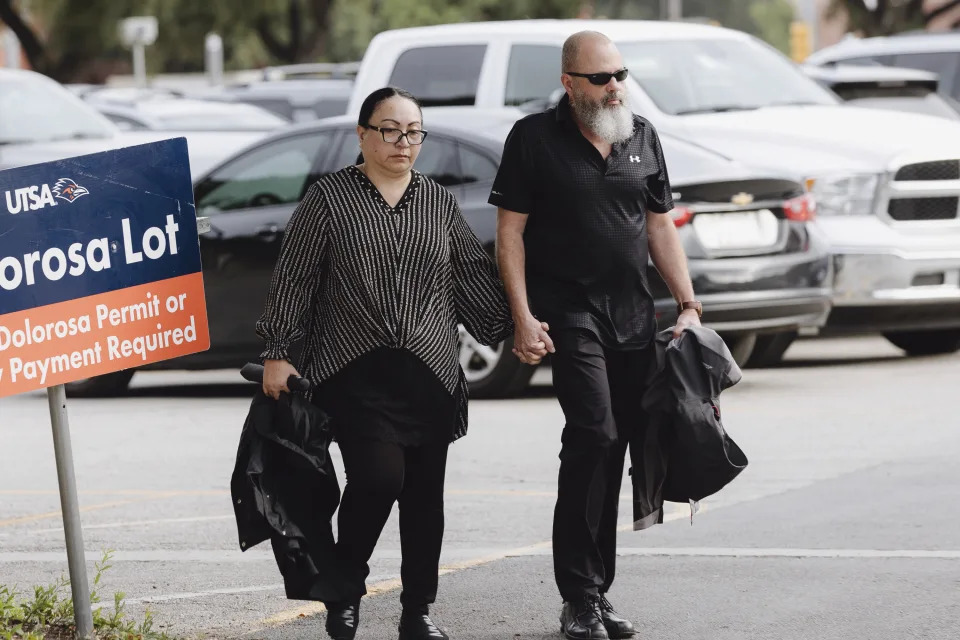 Janet Yamanaka Mello, left, an ex-civilian employee of the U.S. Army convicted of stealing $109 million from a youth development program for children of military families, and her husband, Mark Mello, walk into the federal courthouse Tuesday, July 23, 2024, in San Antonio, Texas. (Christopher Lee/The San Antonio Express-News via AP)