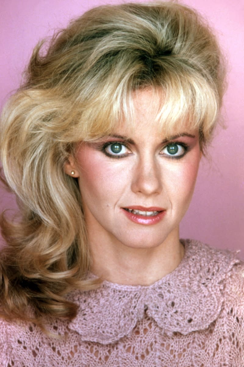 Olivia Newton-John pictured with bold eyeliner, mauve blush and a shiny lipstick