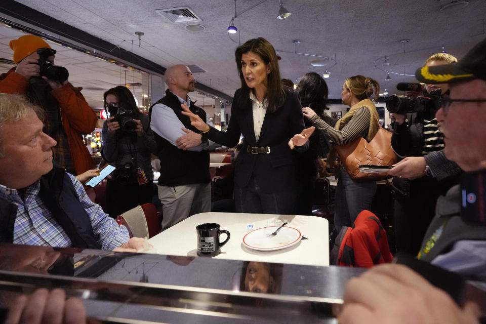 Republican presidential candidate former UN Ambassador Nikki Haley, center, chats with guests during a campaign stop at Mary Ann's Diner, Friday, Jan. 19, 2024, in Amherst, N.H. (AP Photo/Charles Krupa)