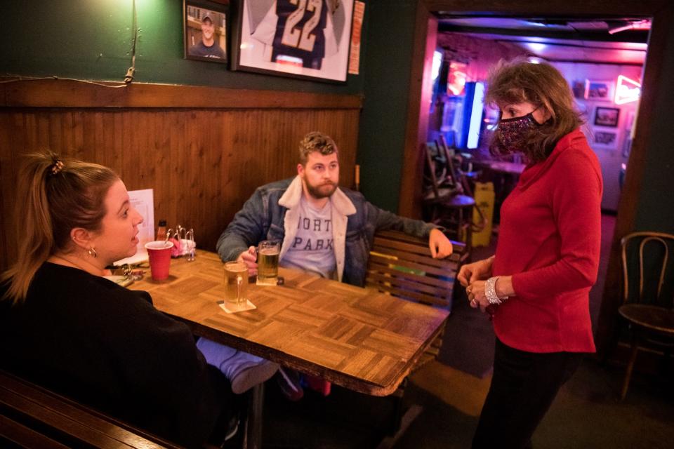 Daphne McFarland, right, takes an order from longtime customer Molly Storey and her friend Nick Estrem at Brown's Diner in  2021. McFarland has been a server at Brown’s for over three decades.