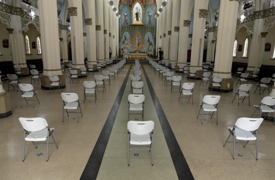 Chairs are placed at a distance in preparation for the first Mass at the Our Lady of Mount Carmel since the lockdown to curb COVID-19 as it is partially lifted in Panama City, Monday, Aug. 17, 2020. After nearly five months of quarantine, on Monday Panama is starting a partial reopening of the economy, with barbers, beauty salons, retail, and car lots opening their doors, in an effort to revive the economy while preparing for another possible spike in coronavirus cases. (AP Photo/Arnulfo Franco)