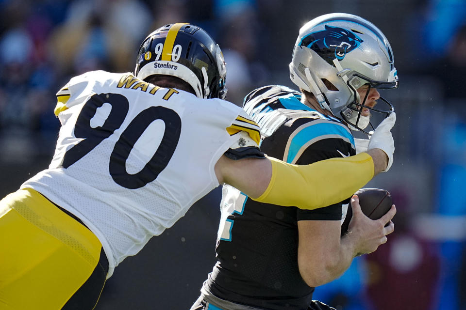 Carolina Panthers quarterback Sam Darnold is sacked by Pittsburgh Steelers linebacker T.J. Watt during the first half of an NFL football game between the Carolina Panthers and the Pittsburgh Steelers on Sunday, Dec. 18, 2022, in Charlotte, N.C. (AP Photo/Rusty Jones)