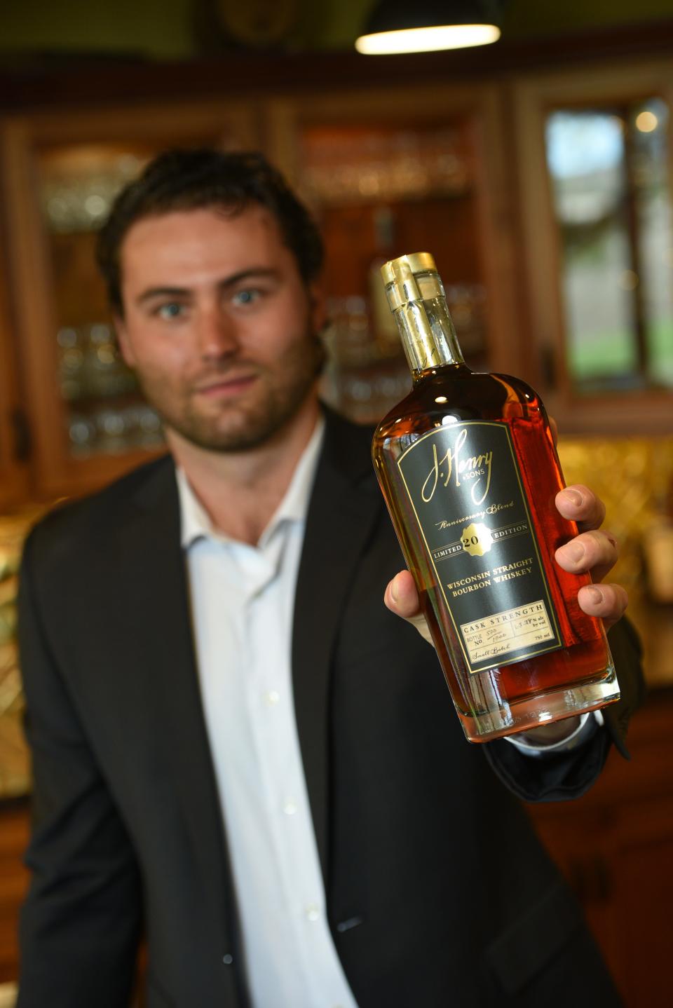 Joe Z. Henry, master blender at J. Henry & Sons, holds a bottle of the distillery's Anniversary blend.