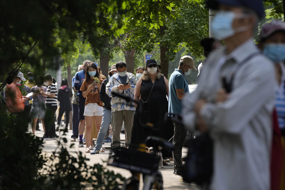 Residents line up for mass COVID test, Tuesday, June 14, 2022, in Beijing. (AP Photo/Ng Han Guan)