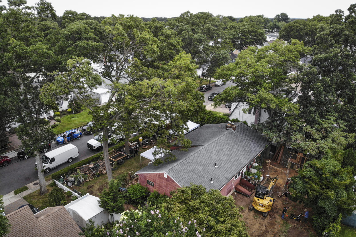 Image: Authorities continue to work at the home of suspect Rex Heuermann, bottom right, in Massapequa Park, N.Y., on July 24, 2023. (Seth Wenig / AP)