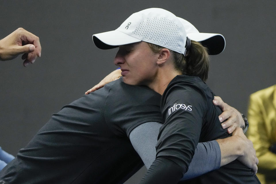 Iga Swiatek of Poland is congratulated by her team members after defeating Liudmila Samsanova of Russia in the women's singles final match of the China Open tennis tournament at the Diamond Court in Beijing, Sunday, Oct. 8, 2023. (AP Photo/Andy Wong)