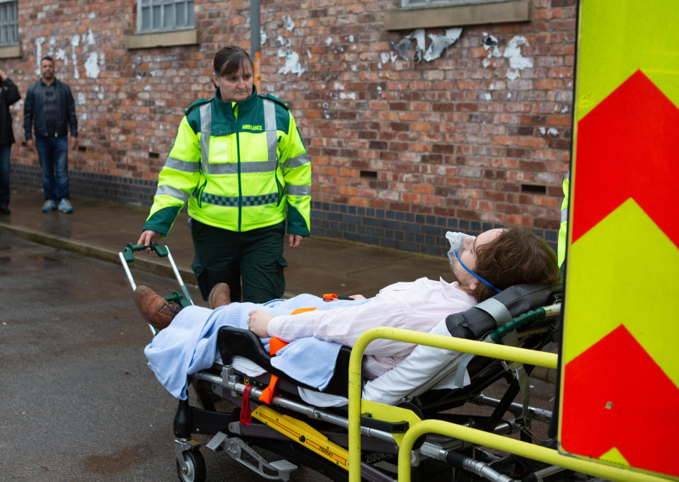 Maria Connor [SAMIA LONGCHAMBON] and Gary Windass [MIKEY NORTH] watch in horror as Ali Neeson [JAMES BURROWS] is loaded into an ambulance.   (ITV Plc)