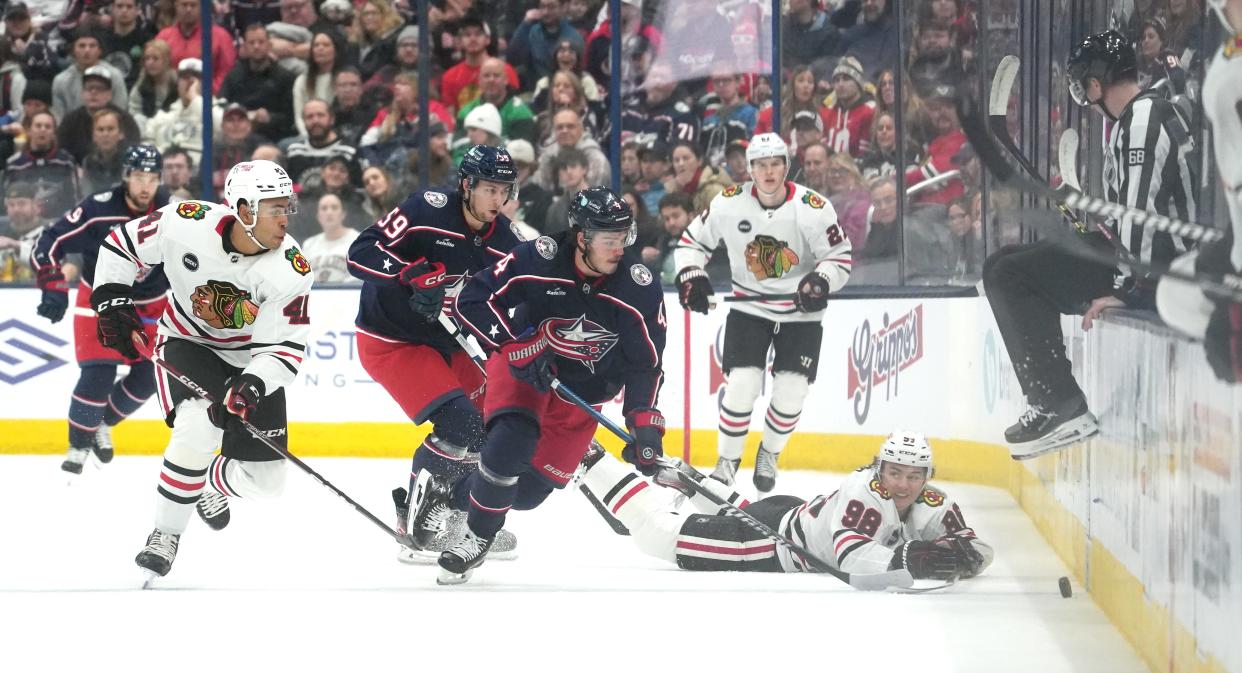 Nov 22, 2023; Columbus, Ohio, USA; Columbus Blue Jackets Center Cole Sillinger takes the puck away from Chicago Blackhawk Connor Bedard during the second period of the NHL hockey game at Nationwide Arena in Columbus on November 22, 2023.