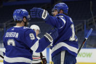 Tampa Bay Lightning left wing Alex Killorn (17) celebrates with center Tyler Johnson (9) after Killorn scored against the Chicago Blackhawks during the second period of an NHL hockey game Friday, Jan. 15, 2021, in Tampa, Fla. (AP Photo/Chris O'Meara)