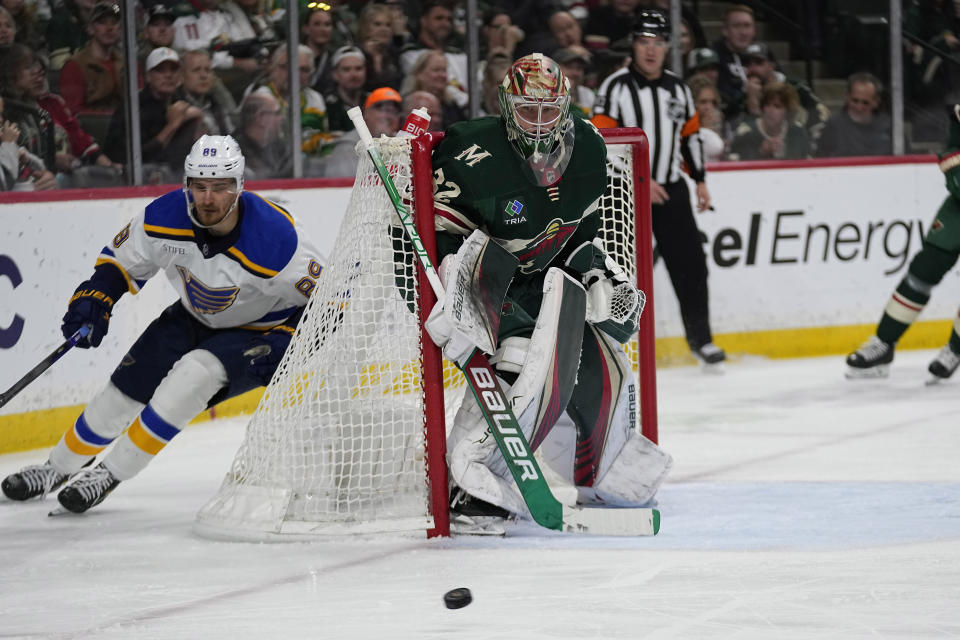 Minnesota Wild goaltender Filip Gustavsson, center, watches the puck during the second period of an NHL hockey game against the St. Louis Blues, Saturday, April 8, 2023, in St. Paul, Minn. (AP Photo/Abbie Parr)