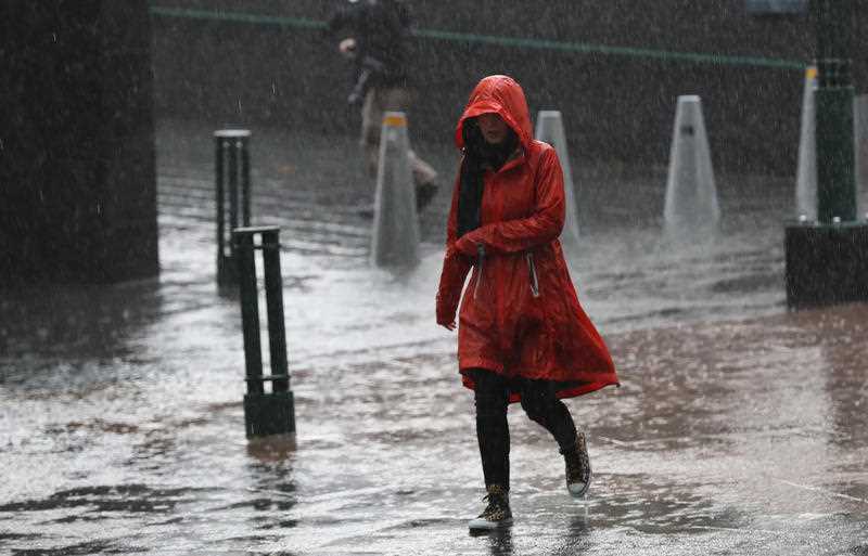 Pedestrians are seen in the rain on Southbank in Melbourne.