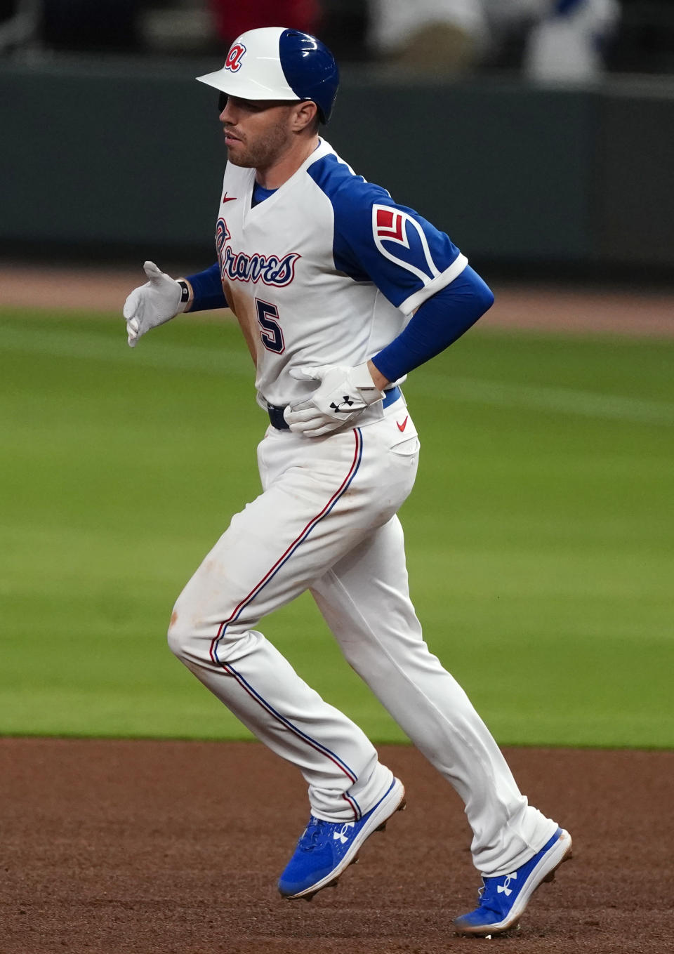 Atlanta Braves' Freddie Freeman (5) rounds the bases after hitting a two-run home run in the eighth inning of a baseball game against the Philadelphia Phillies, Friday, April 9, 2021, in Atlanta. (AP Photo/John Bazemore)