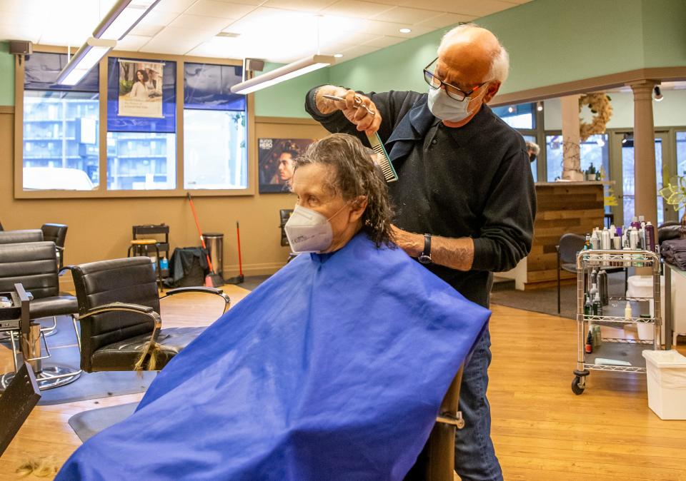 Ron DeWinter, owner of Hair Crafters, cuts Janet Bettcher’s hair on Friday, Dec. 10, 2021, inside Hair Crafters in South Bend. 