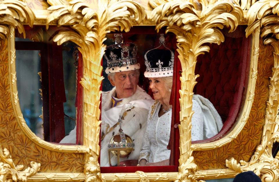 King Charles and Queen Camilla in the Gold State Coach after the coronation ceremony