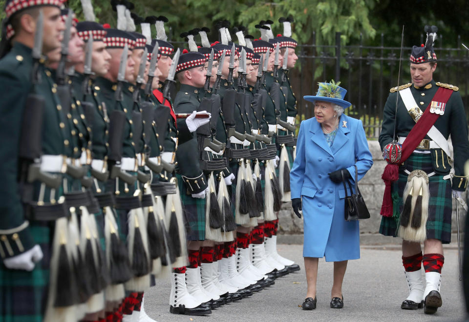 Queen Elizabeth II, with Officer Commanding Major Johnny Thompson, inspects Balaclava Company, 5 Battalion The Royal Regiment of Scotland at the gates at Balmoral, as she takes up summer residence at the castle. (Photo by Andrew Milligan/PA Images via Getty Images)