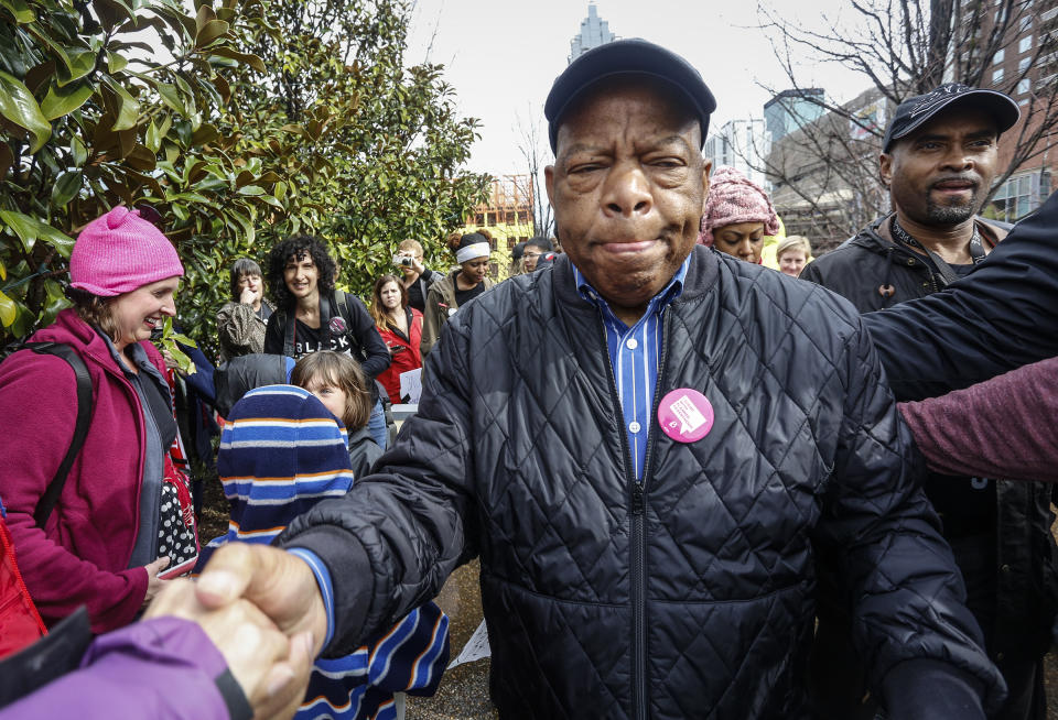 Rep. John Lewis reaches out to shake the hands of well-wishers as he arrives at the Women's March on Saturday, Jan. 21, 2017, in Atlanta. (Photo: Ron Harris/AP)