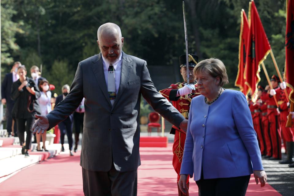 Albanian Prime Minister Edi Rama, left, and the German Chancellor Angela Merkel join the welcome ceremony at the Palace of Brigades in Tirana, Albania, Tuesday, Sept. 14, 2021. Merkel is on a farewell tour of the Western Balkans, as she announced in 2018 that she wouldn't seek a fifth term as Germany's Chancellor. (AP Photo/Franc Zhurda)