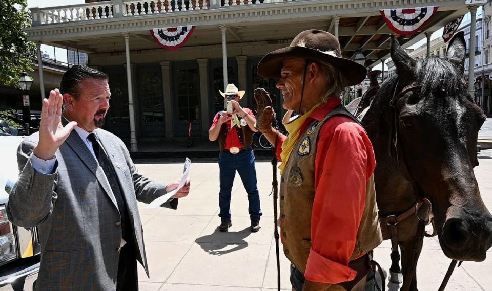 Sacramento Postmaster Douglas Smith swears in Steve Pool, who rode the first leg of Pony Express re-ride from Old Sacramento on Wednesday, June 16, 2021. The express ride returns after taking a year off during COVID.