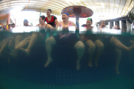 Elderly people attend an aquatic exercise at a private pool in Bangkok, Thailand, April 28, 2016. REUTERS/Athit Perawongmetha