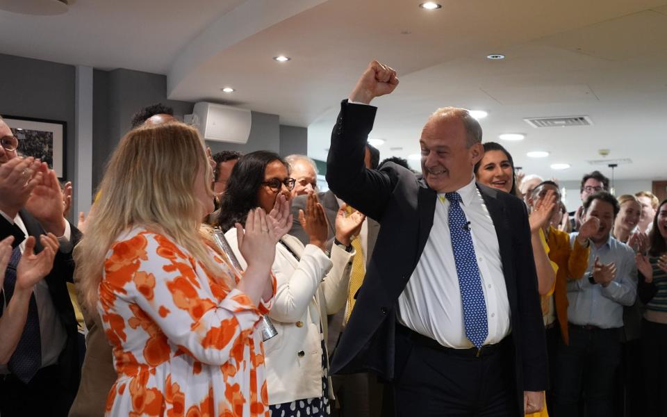 Sir Ed Davey punching the air as he is greeted by Liberal Democrat supporters and activists