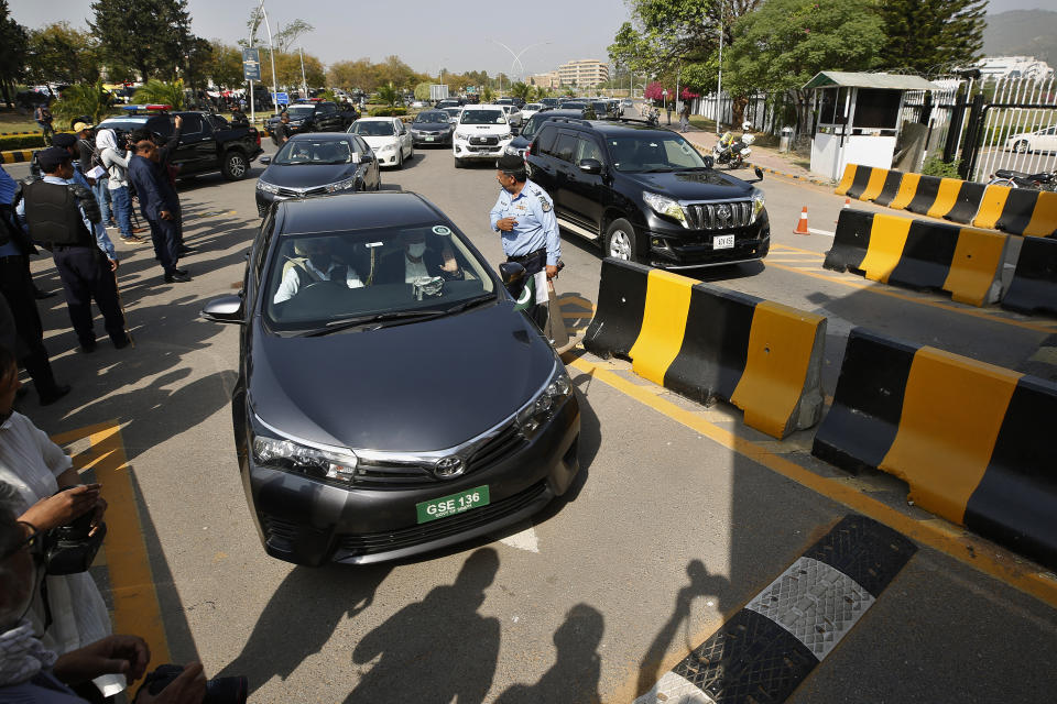 Vehicles of Pakistani lawmakers arrives at National Assembly to attend a session in Islamabad, Pakistan, Saturday, April 9, 2022. Pakistan's embattled prime minister faces a tough no-confidence vote Saturday waged by his political opposition, which says it has the numbers to defeat him. (AP Photo/Anjum Naveed)