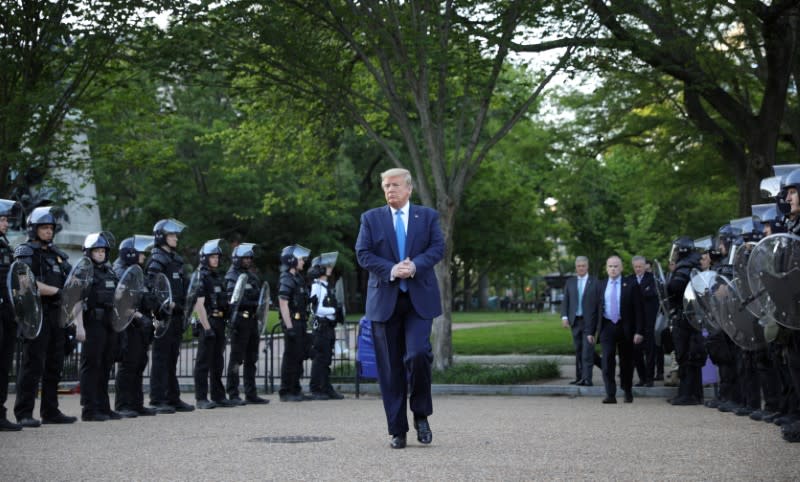 U.S. President Trump walks between lines of riot police in Washington