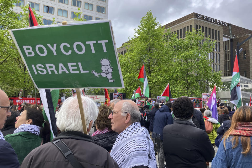 Demonstrators demanding the boycott of Israel during Olympic Games demonstrate outside the Paris Olympic organizing committee headquarters, Tuesday, April 30, 2024 in Saint-Denis, outside Paris. About 300 pro-Palestinian demonstrators took part on the protest. (AP Photo/Alexander Turnbull)