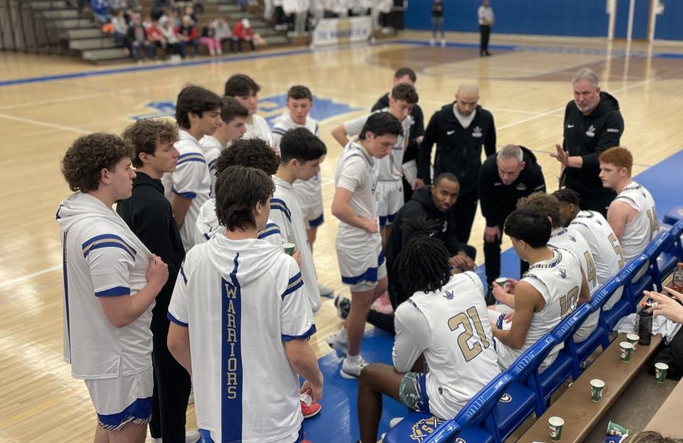 Webster Schroeder coach Rashaad Stokelin gathers his team during a timeout of a 51-50 loss to Penfield in the Section V Class AA quarterfinals. Jack Kelly, 10, led the Warriors with 16 points.
