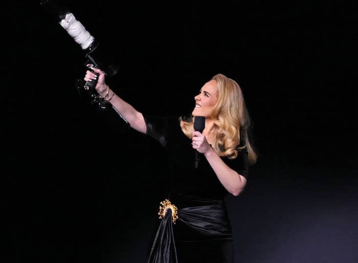 Closeup of Adele onstage shooting a t-shirt into the crowd